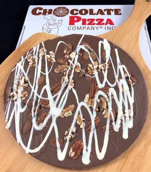 Chocolate Pizza topped with pecans almonds walnuts in a pizza box
