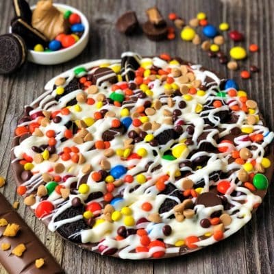 chocolate pizza peanut butter candies on wood planks