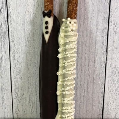 pretzel rods dipped in chocolate and hand decorated for wedding