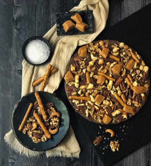 chocolate pizza with caramel, nuts, pretzels