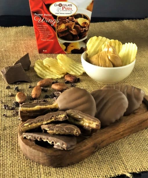 peanut butter wings on wooden tray with potato chips and box
