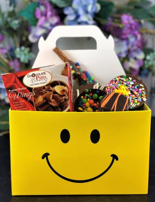 smiles for miles chocolate treats in a yellow smiling face tote box