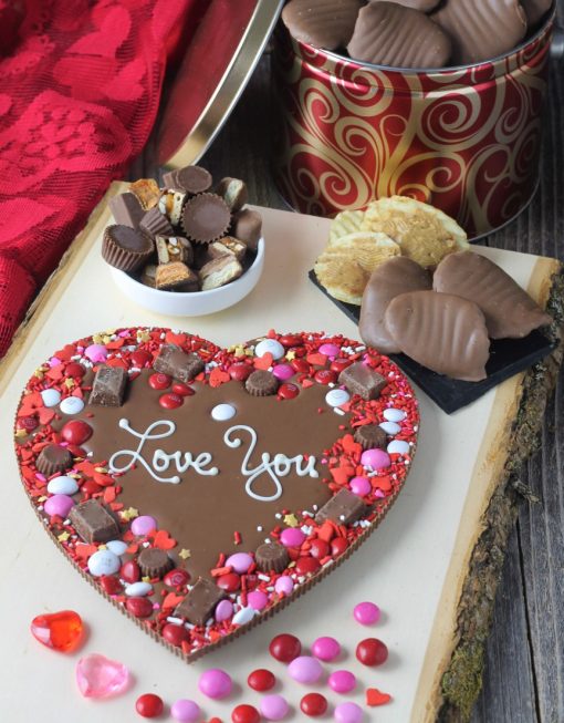 heart shaped chocolate pizza says love you next to peanut butter covered potato chips