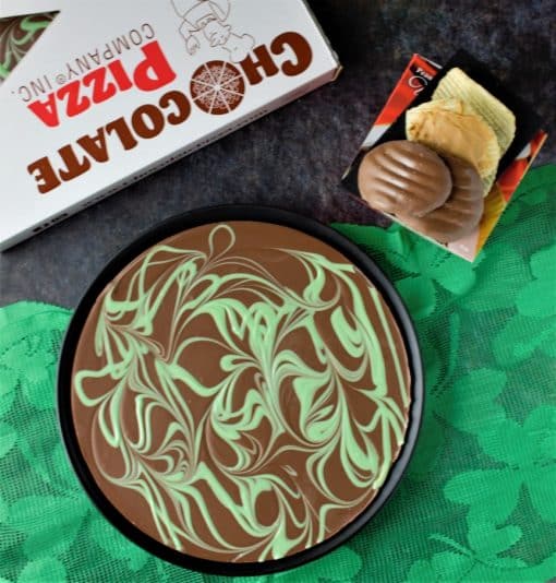 top view of chocolate pizza with green swirls and peanut butter wings