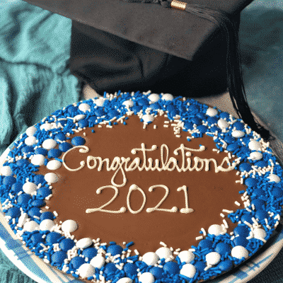 graduation chocolate pizza with blue and white candies